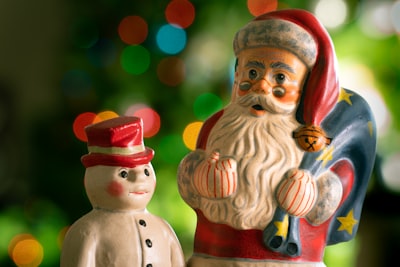 red and brown ceramic figurine kris kringle zoom background