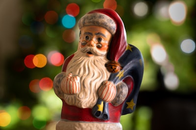 red and brown ceramic figurine kris kringle zoom background