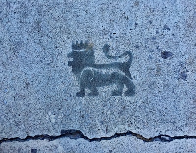 Bold black ink tattoo of a lion’s face on a chest.