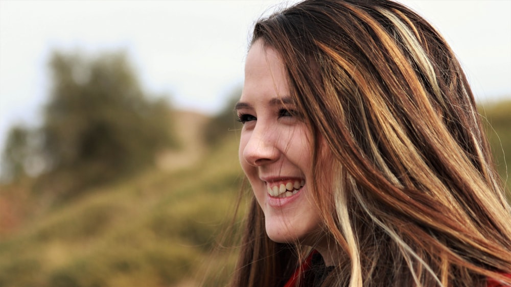 smiling woman in red shirt