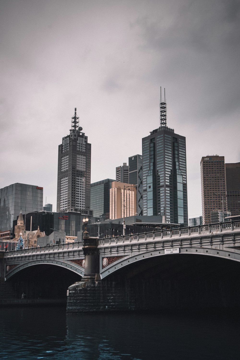 gray concrete bridge over city buildings during daytime