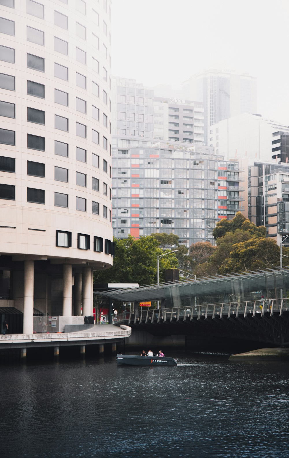 white concrete building near river during daytime