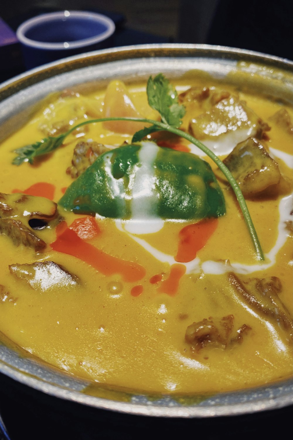 soup with vegetables on stainless steel bowl