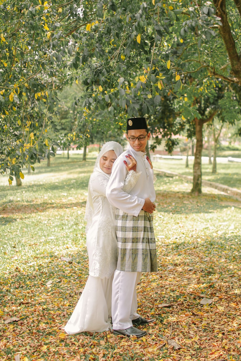 woman in white long sleeve dress standing on green grass field during daytime