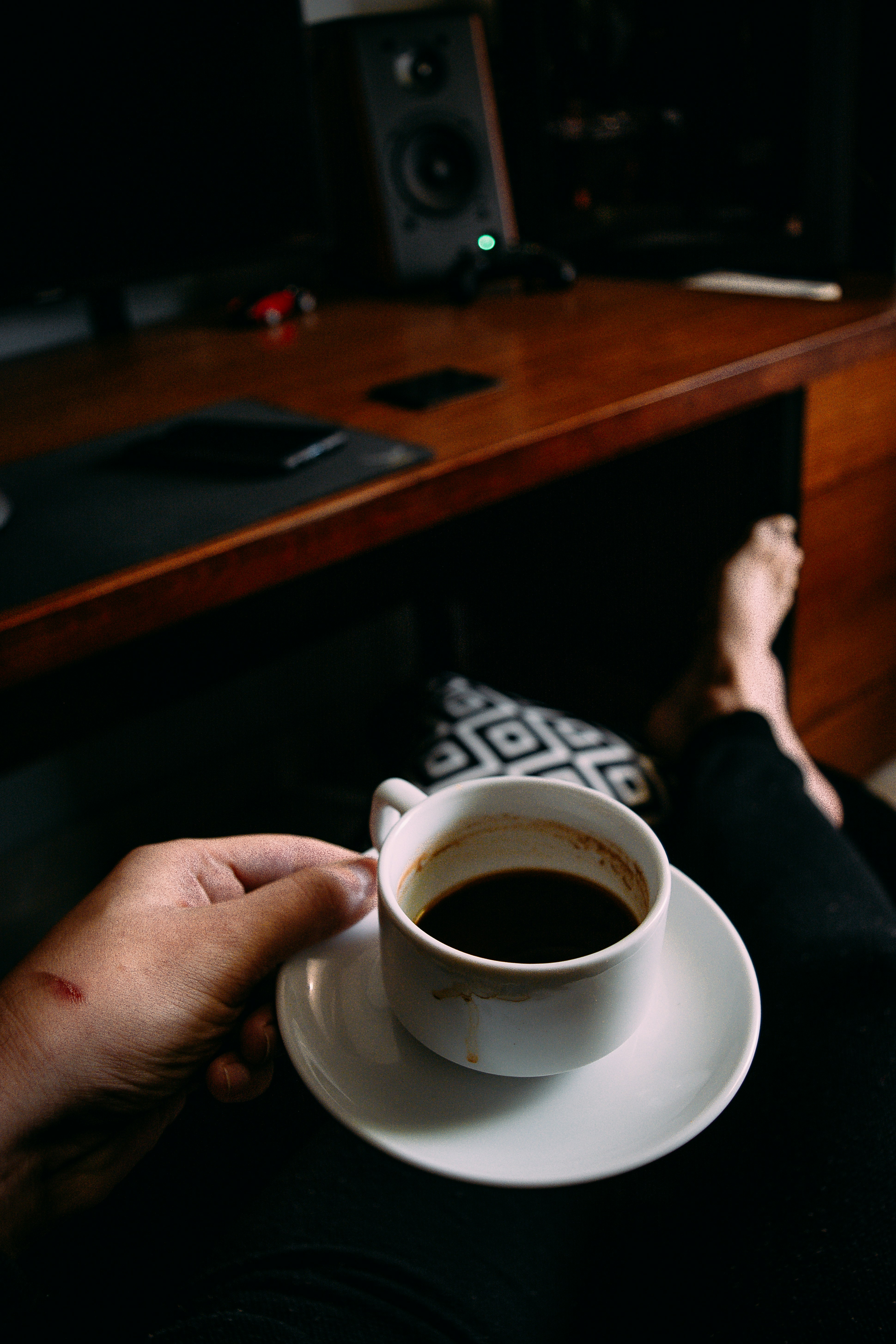 person holding white ceramic cup with coffee