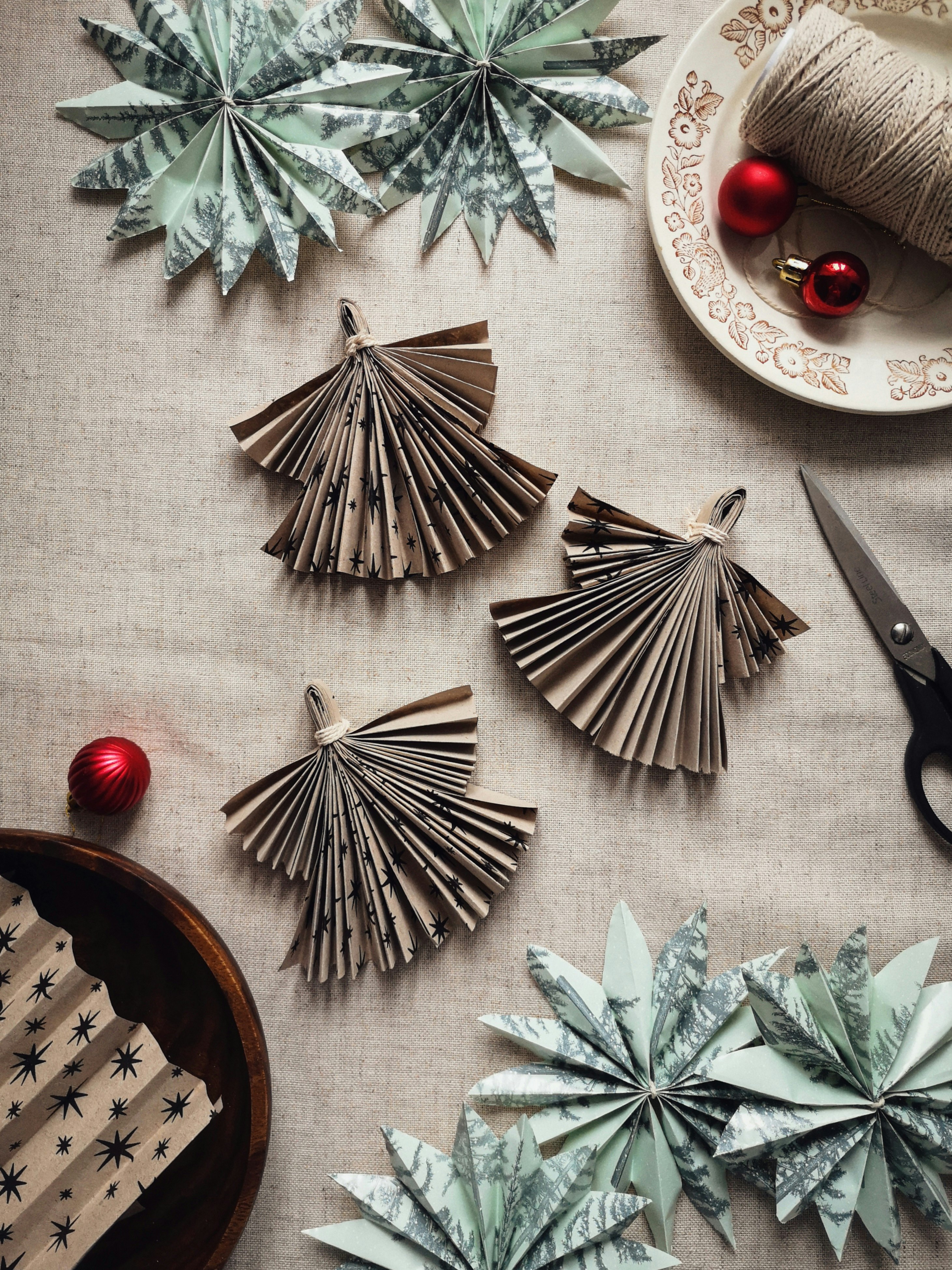 red and gold baubles on white and green pine tree leaves