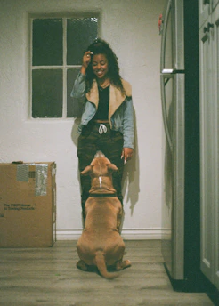 Friendly customer service representative helping a pet owner with a return