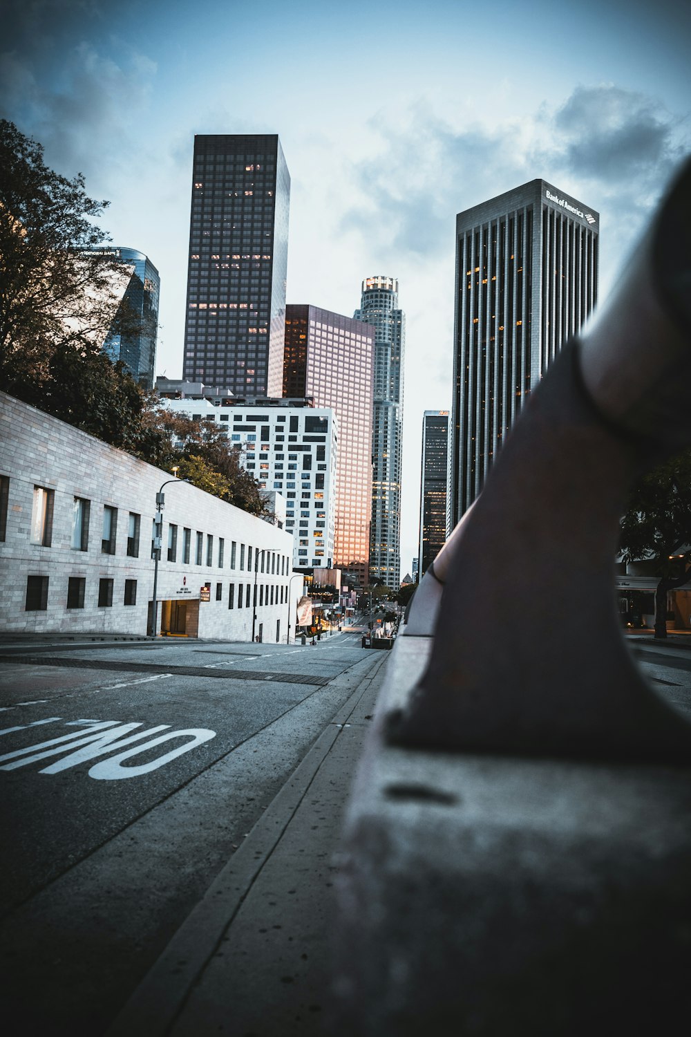 cars on road near high rise buildings during daytime