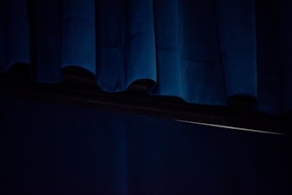 blue window curtain on window