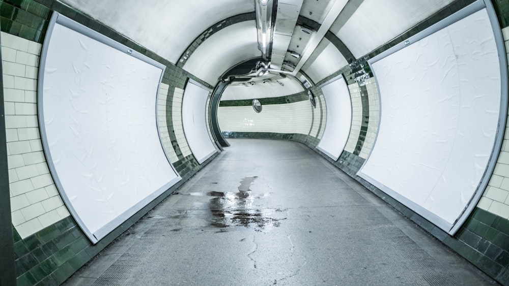 grayscale photo of tunnel with light