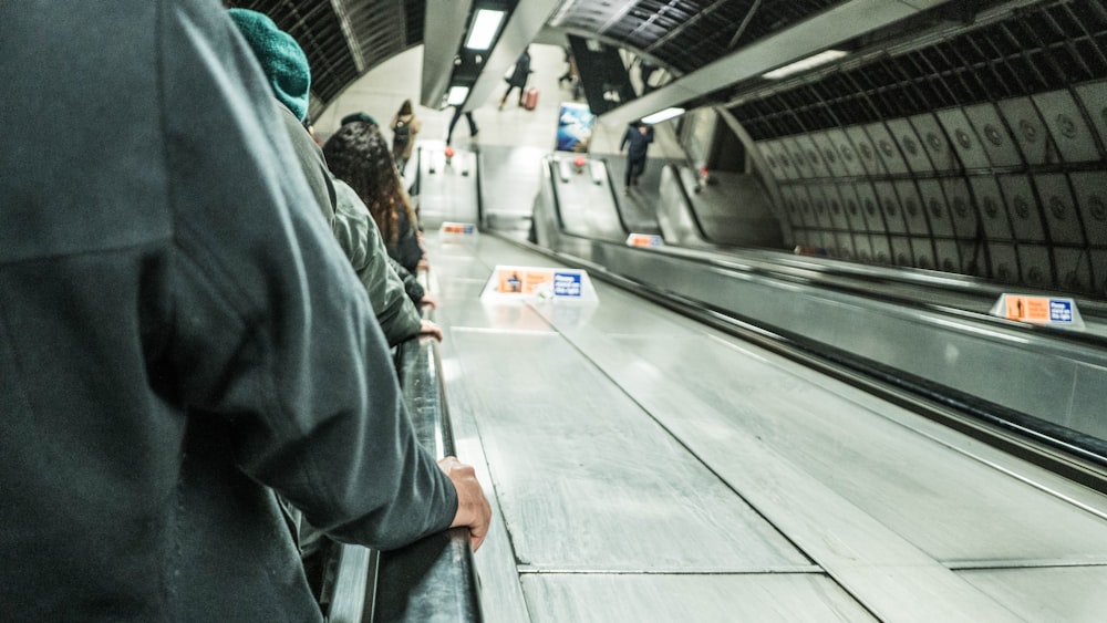 woman in black jacket standing on train station