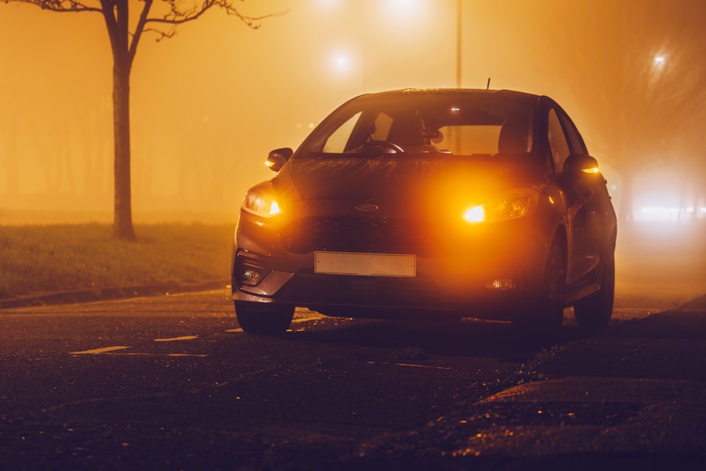 black car on road during sunset