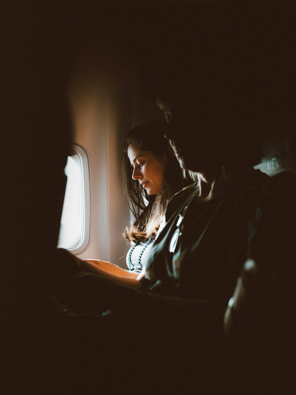 woman in black jacket sitting on chair