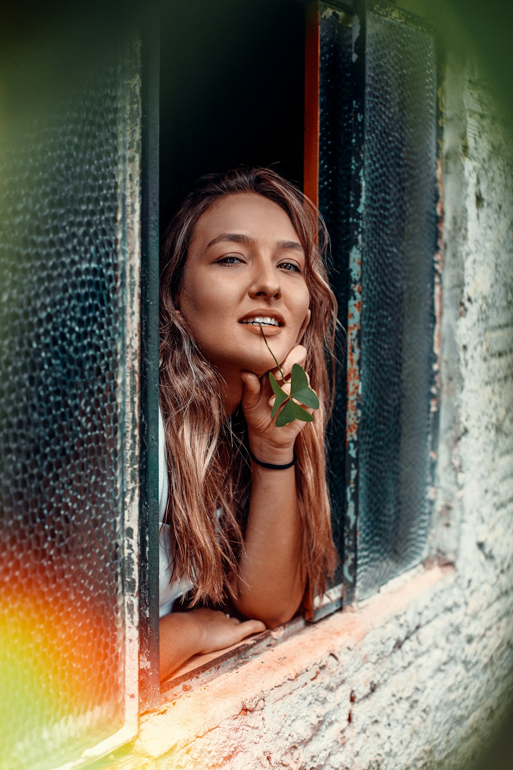 girl in green tank top holding green leaf