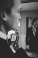 Soft-focus image of a person holding a Dar Al Shiam perfume vial near their wrist