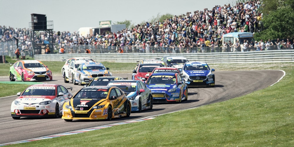 blue and red racing cars on track during daytime