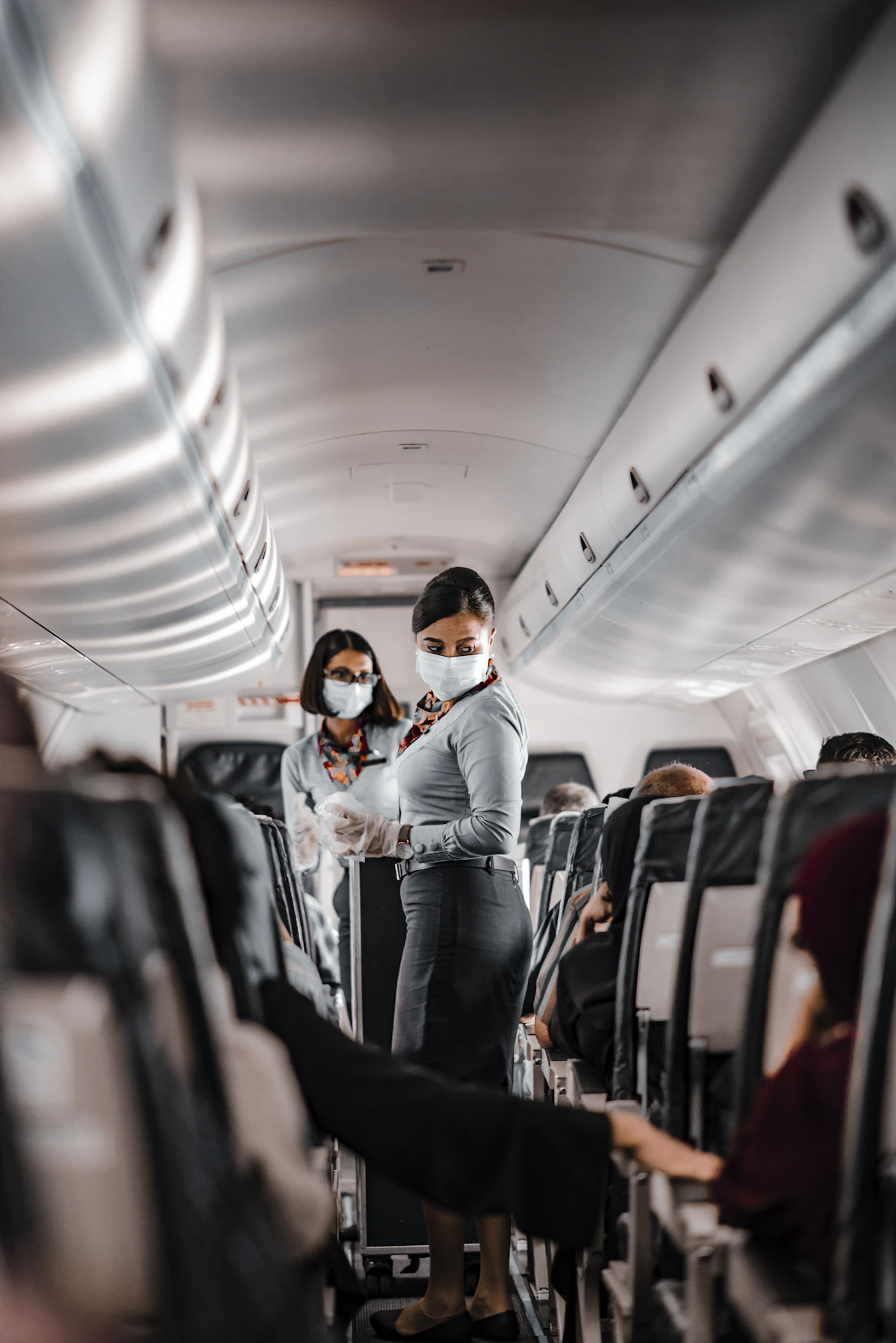 A drink being served to a passenger in an aircraft cabin