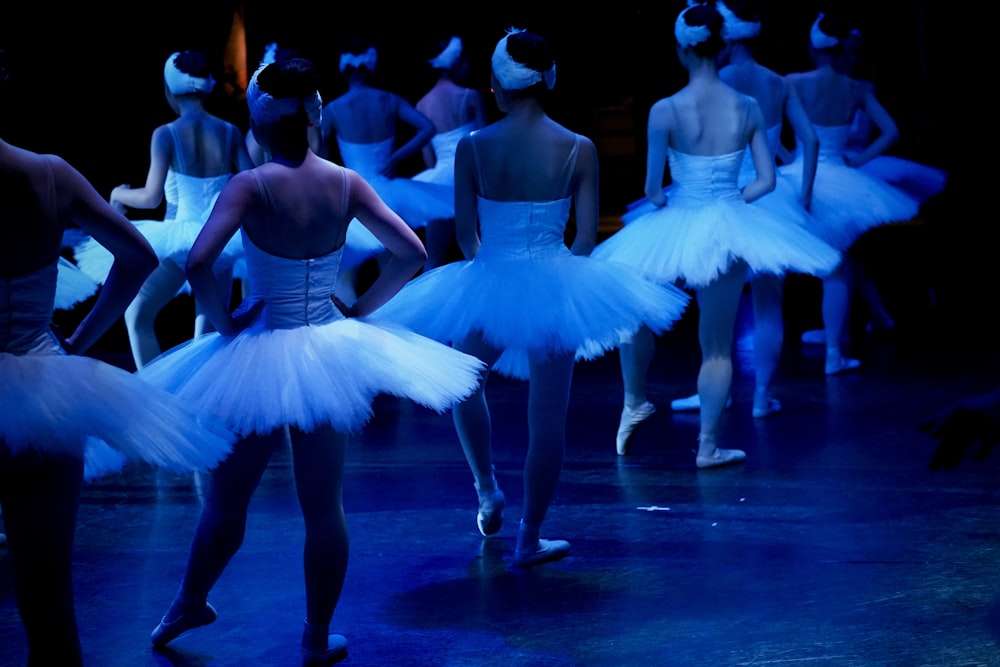 woman in white dress dancing on the stage