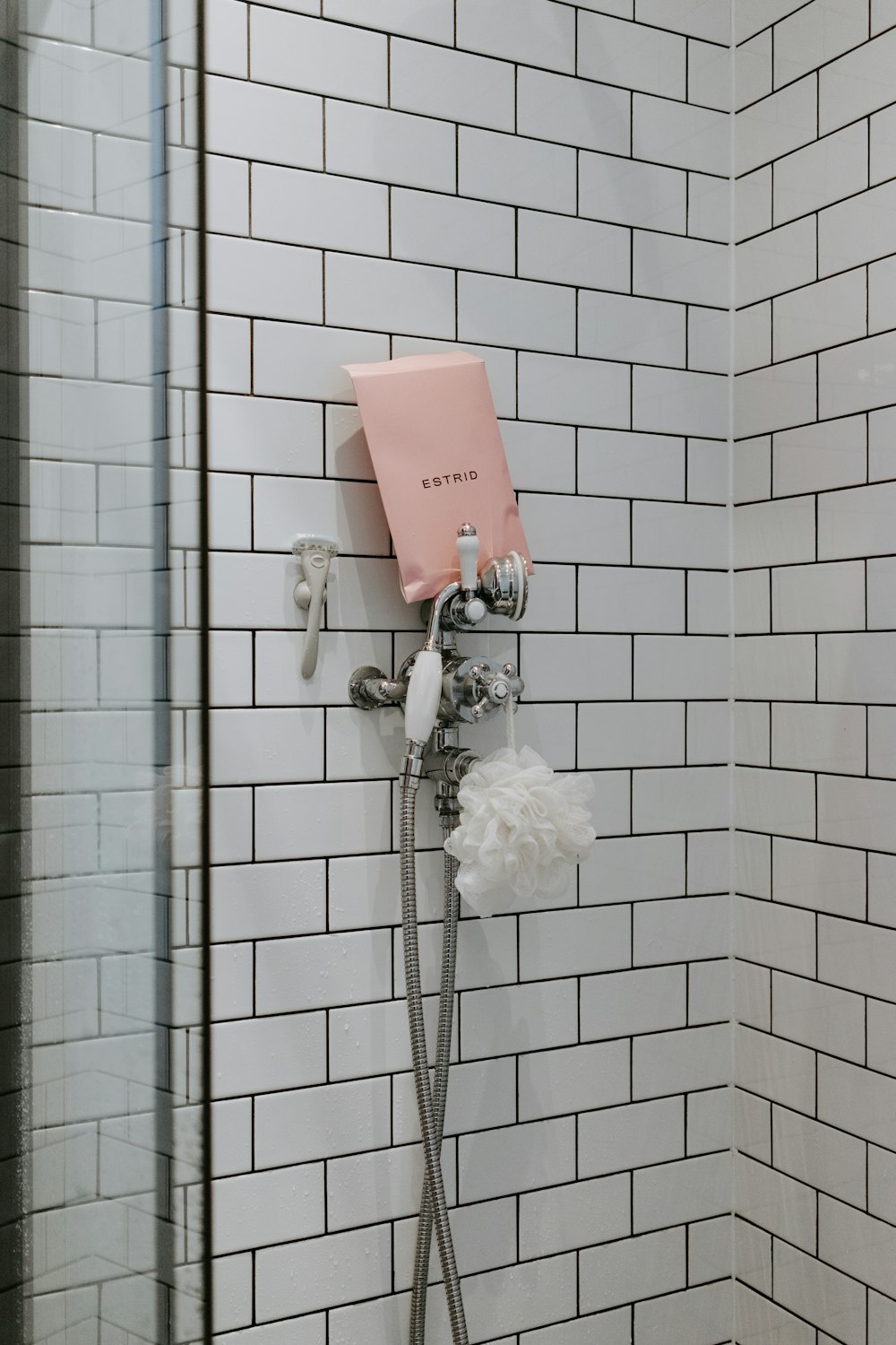 white shower head on white wall tiles