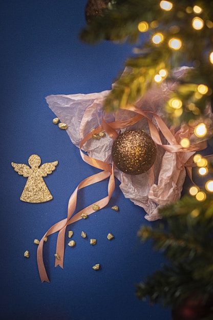 gold and silver baubles on white and brown textile