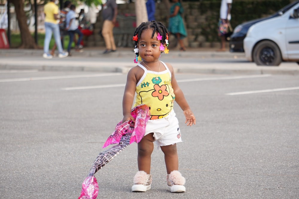 girl in pink tank top running on road during daytime