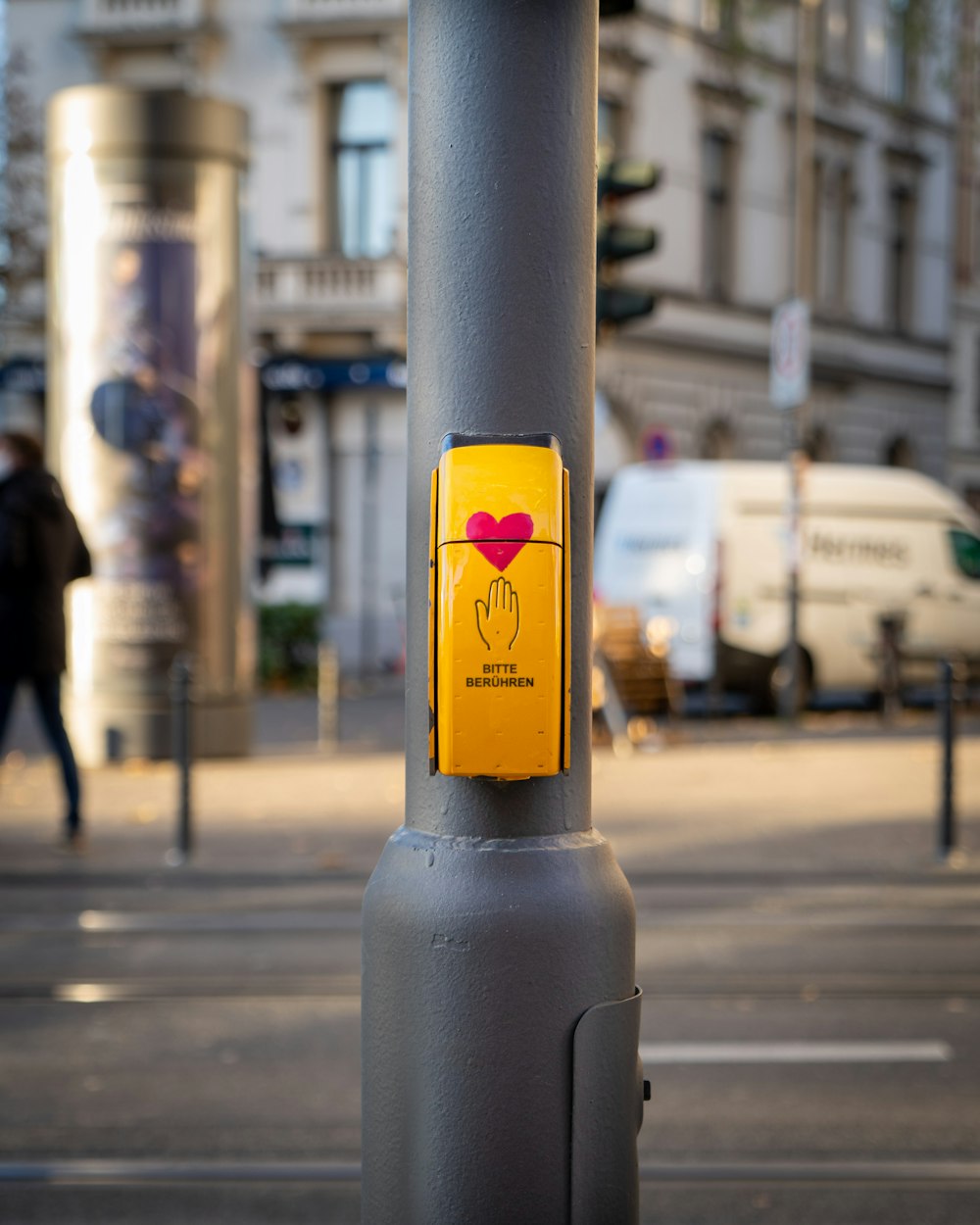 yellow and black sun sticker on gray steel post
