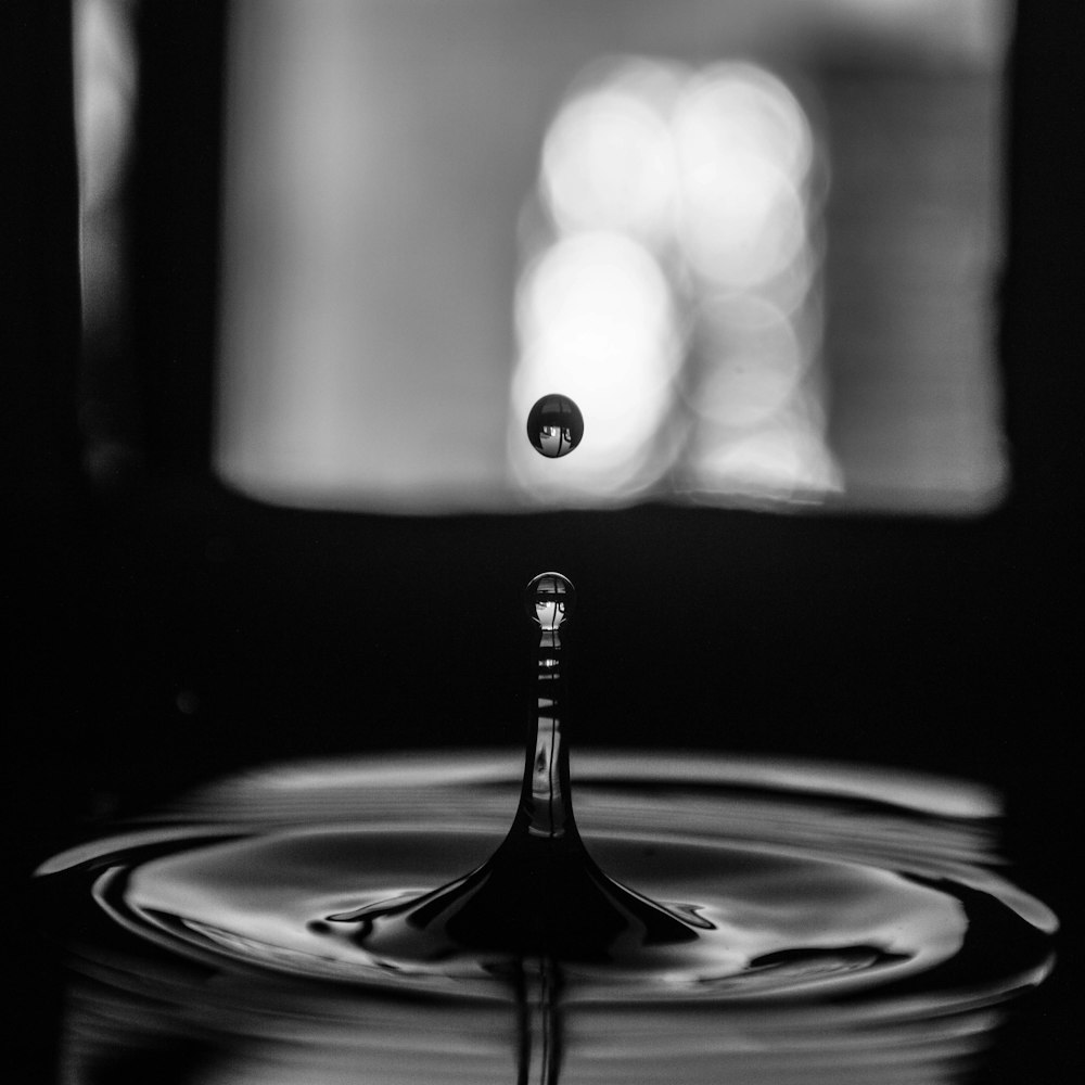 grayscale photo of water drop