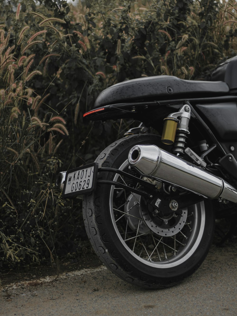 black and silver motorcycle on brown grass field