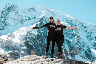 man in black jacket standing on rocky mountain during daytime