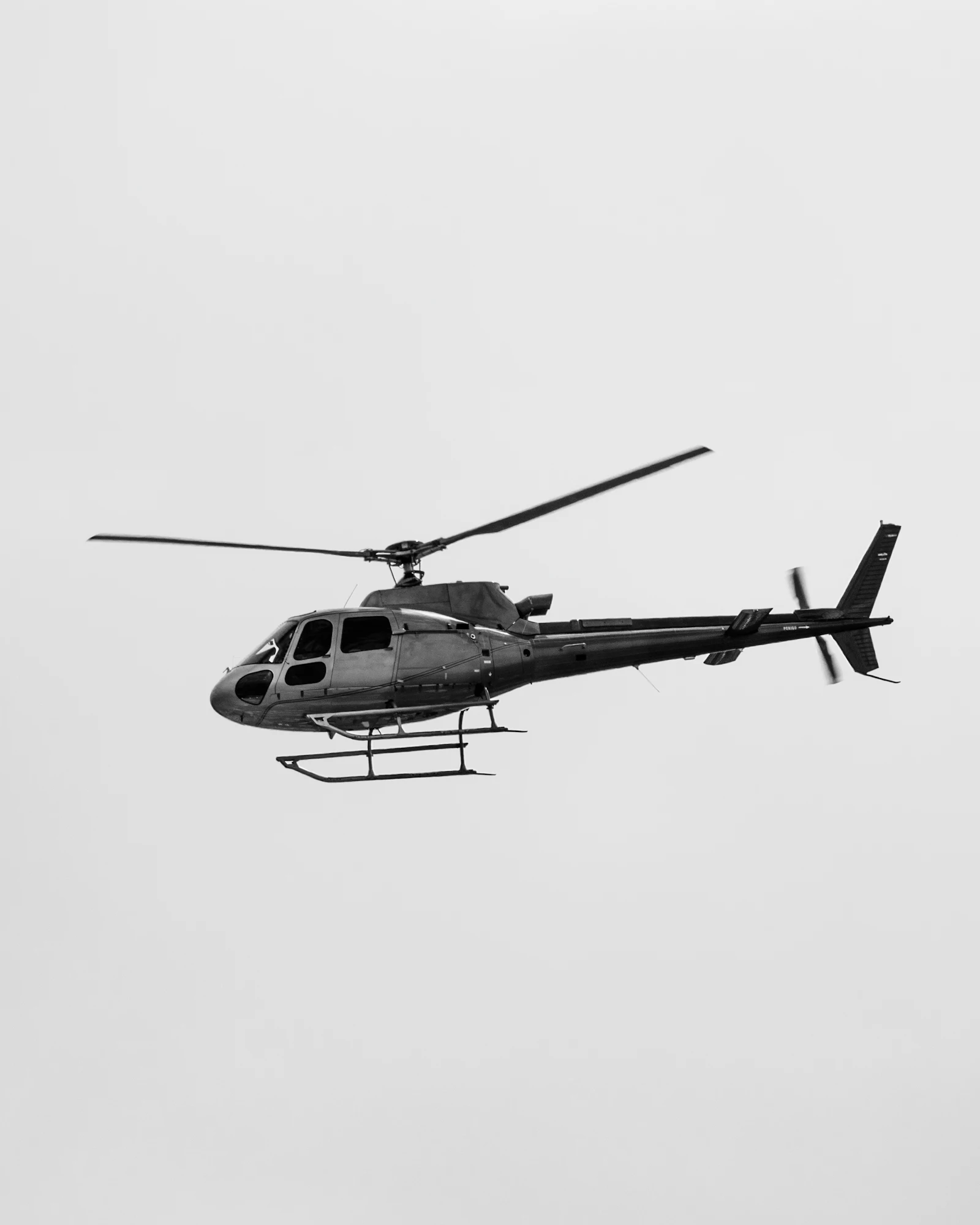 Gray and black helicopter in flight