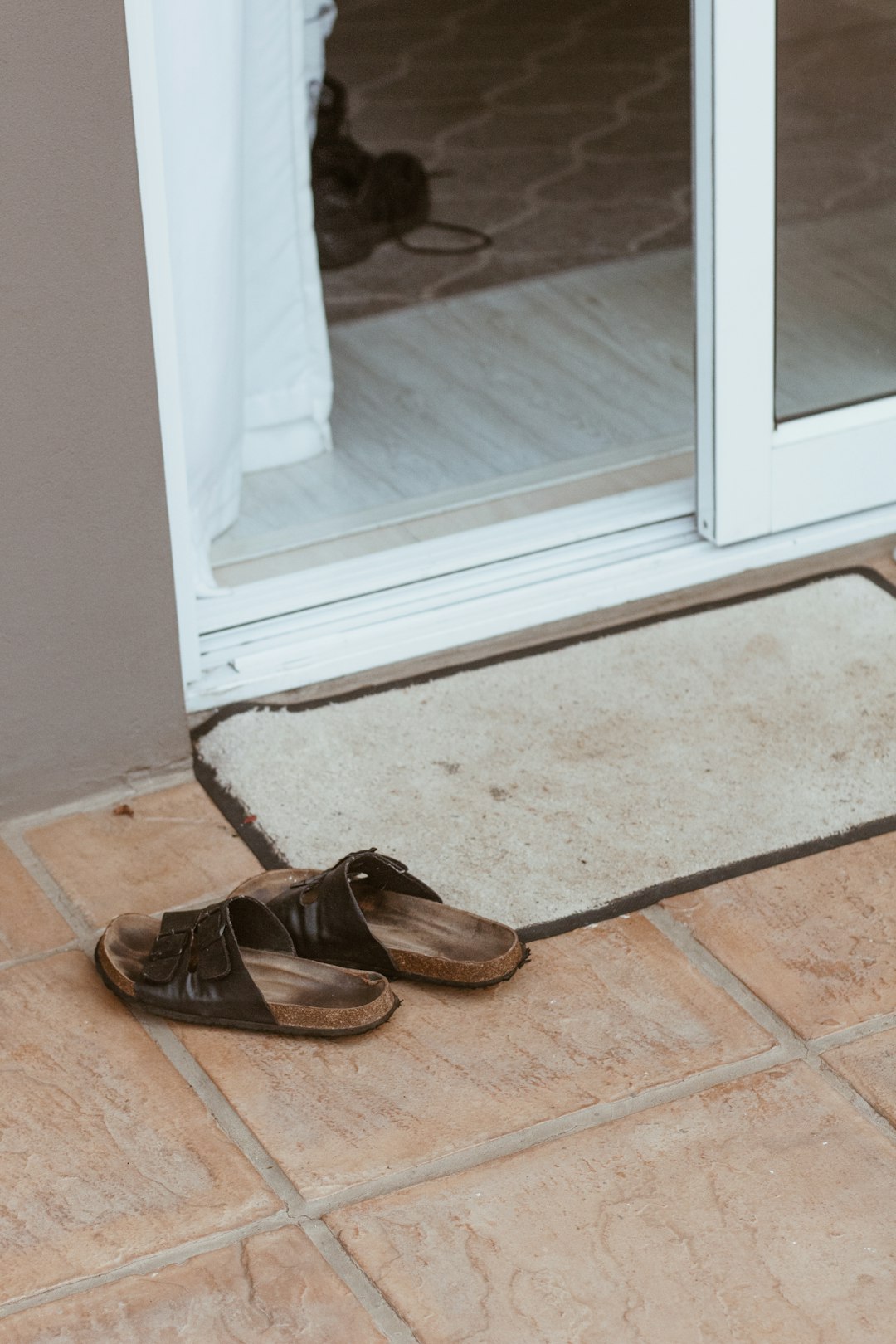  brown leather shoes on floor doormat