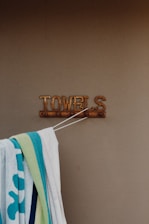 white and blue towel on white plastic hanger
