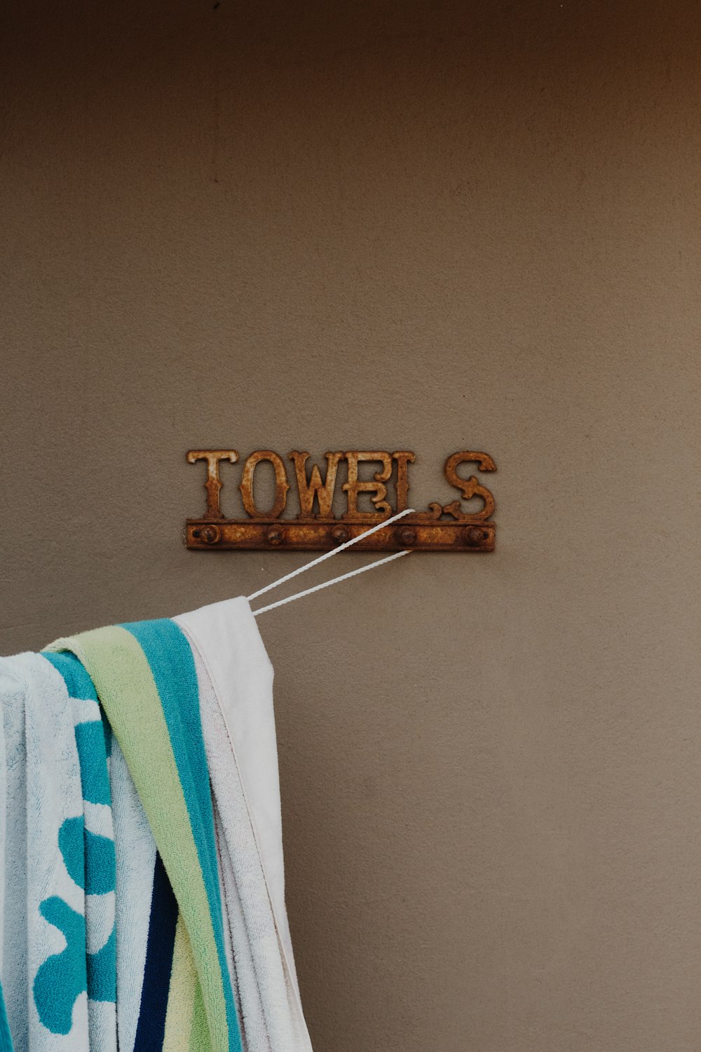 white and blue towel on white plastic hanger