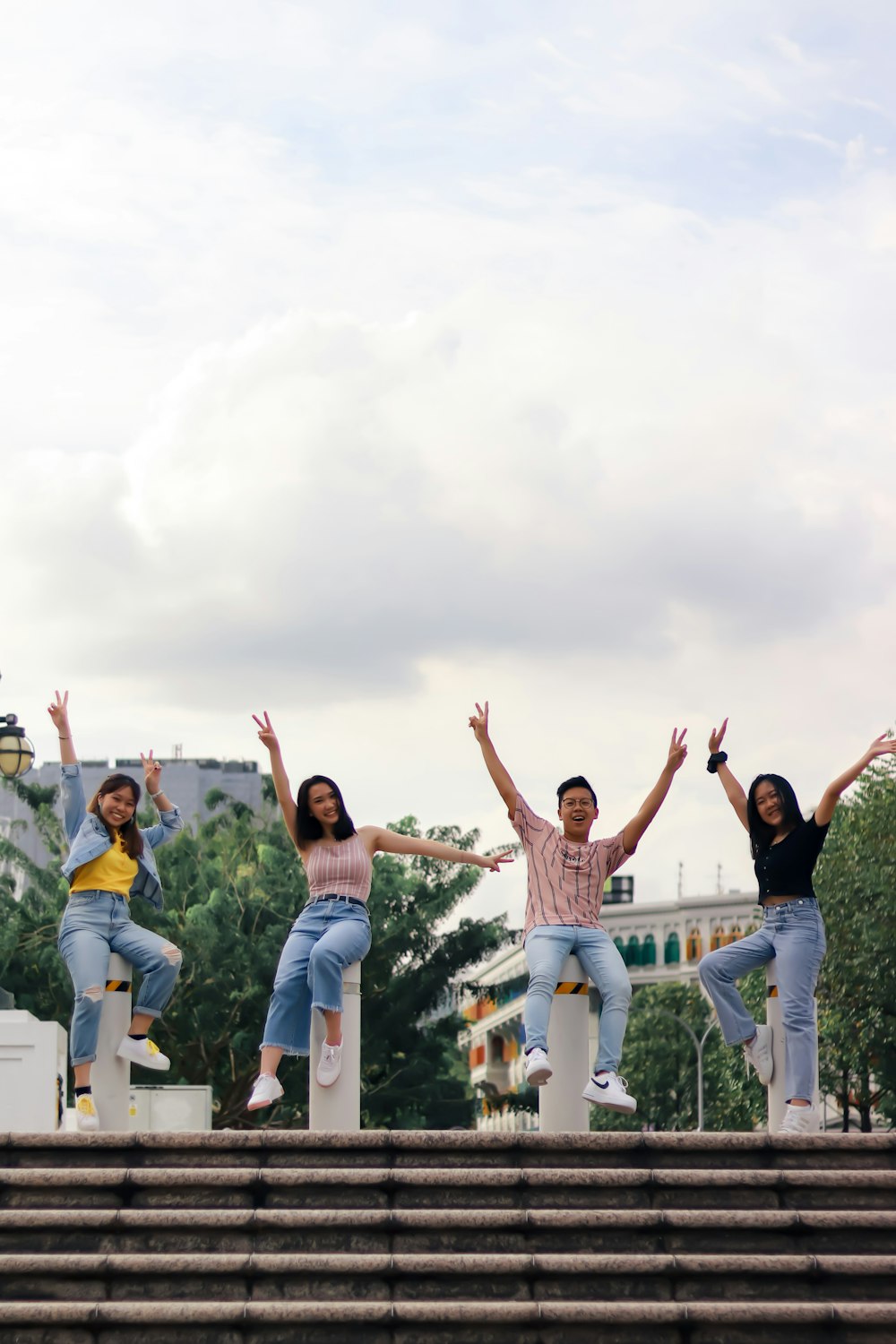 group of people in white shirt and blue denim jeans