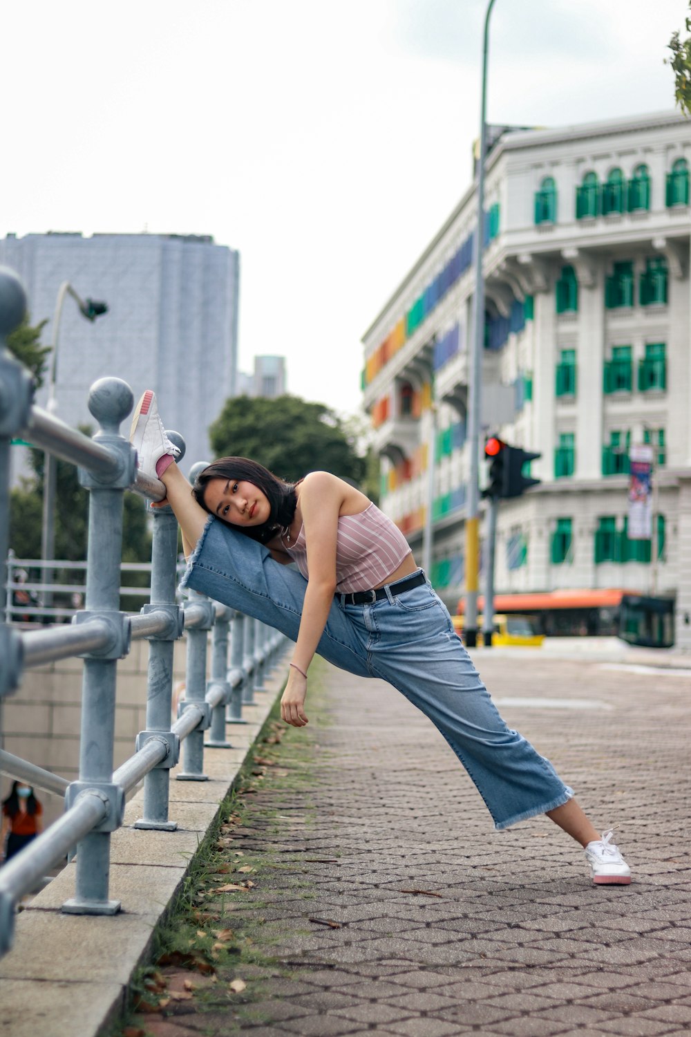 woman in blue denim skirt standing on brown wooden bridge during daytime