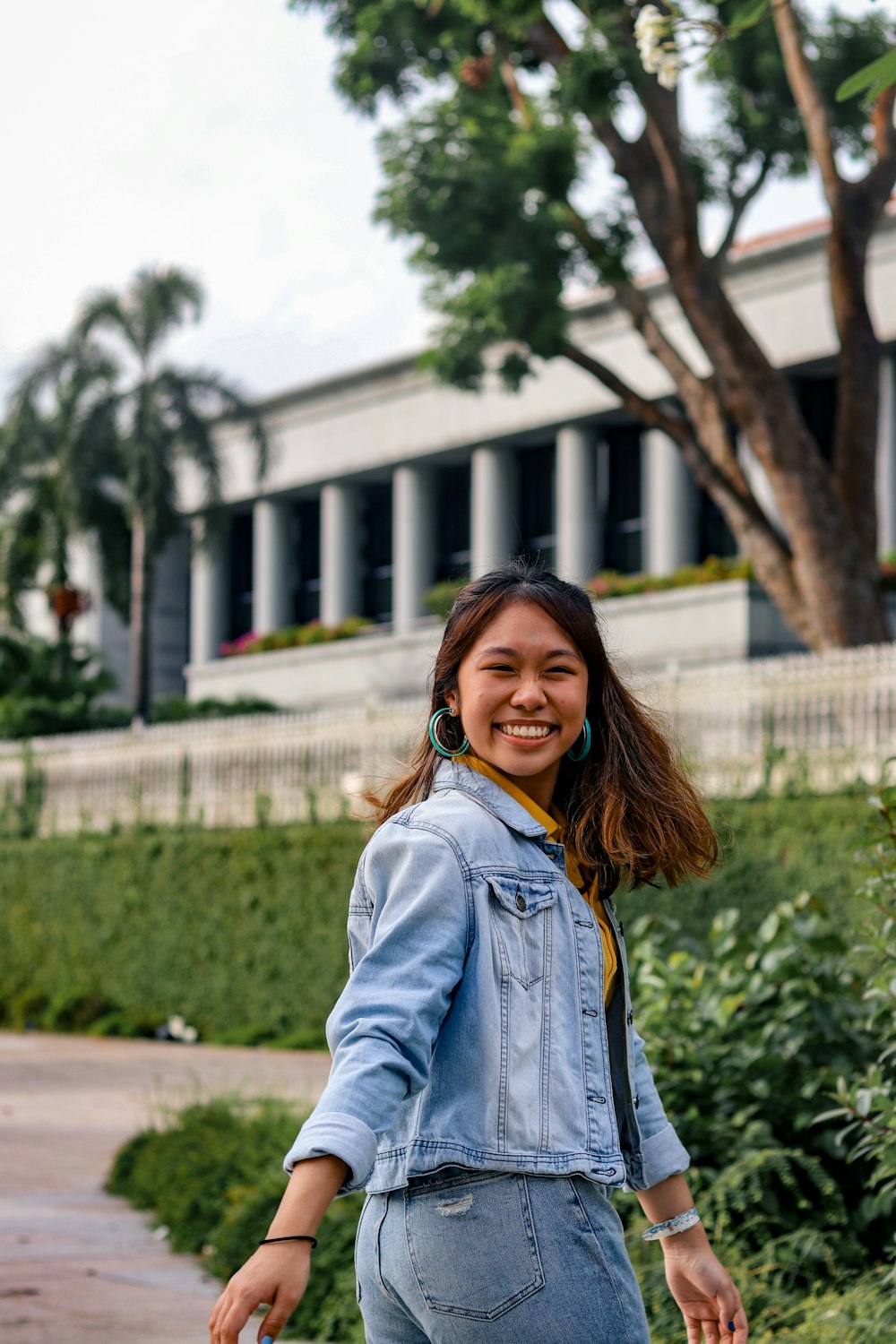 woman in blue denim jacket smiling