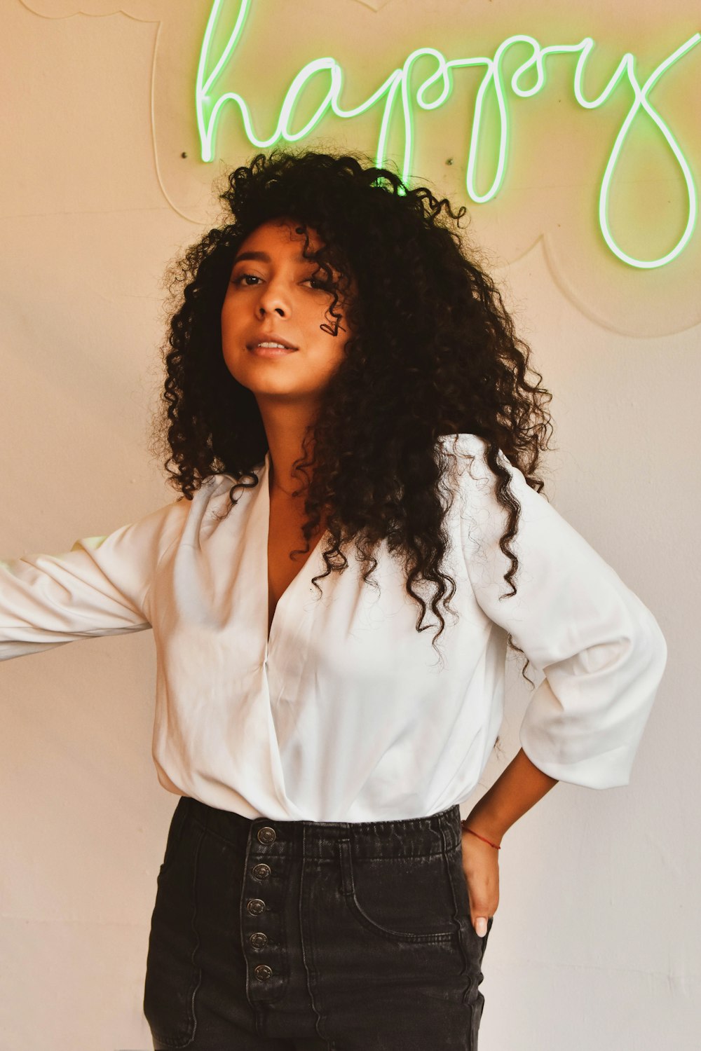 woman in white dress shirt and black pants