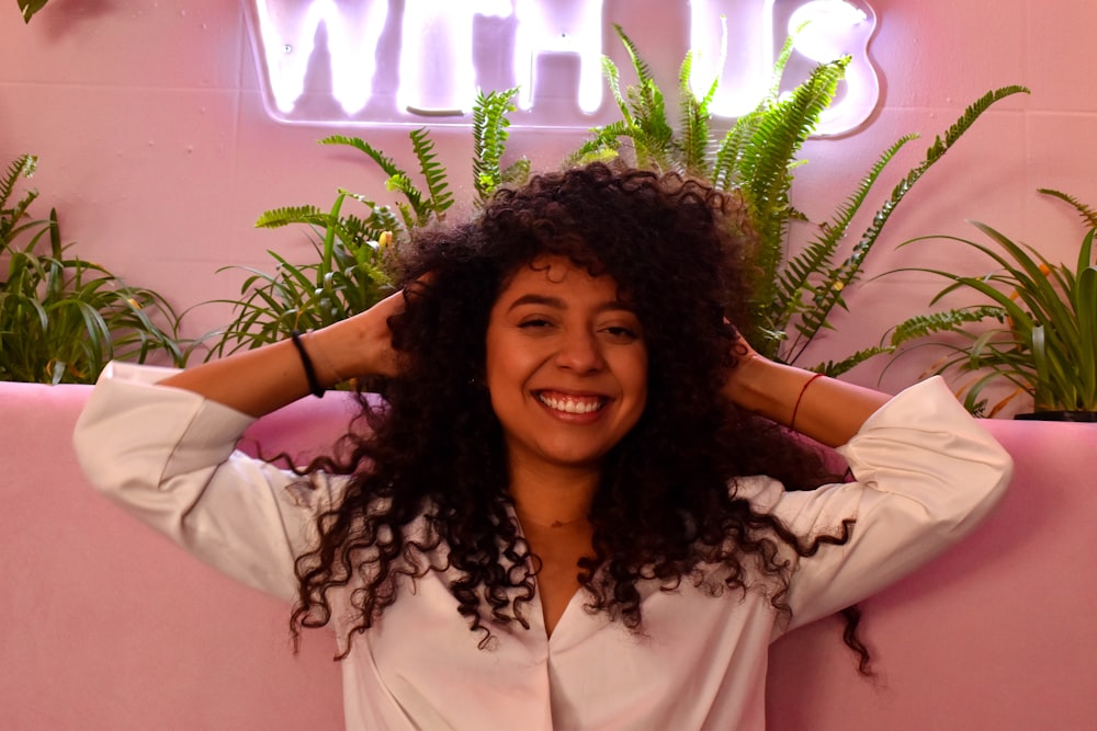 woman in white button up shirt smiling