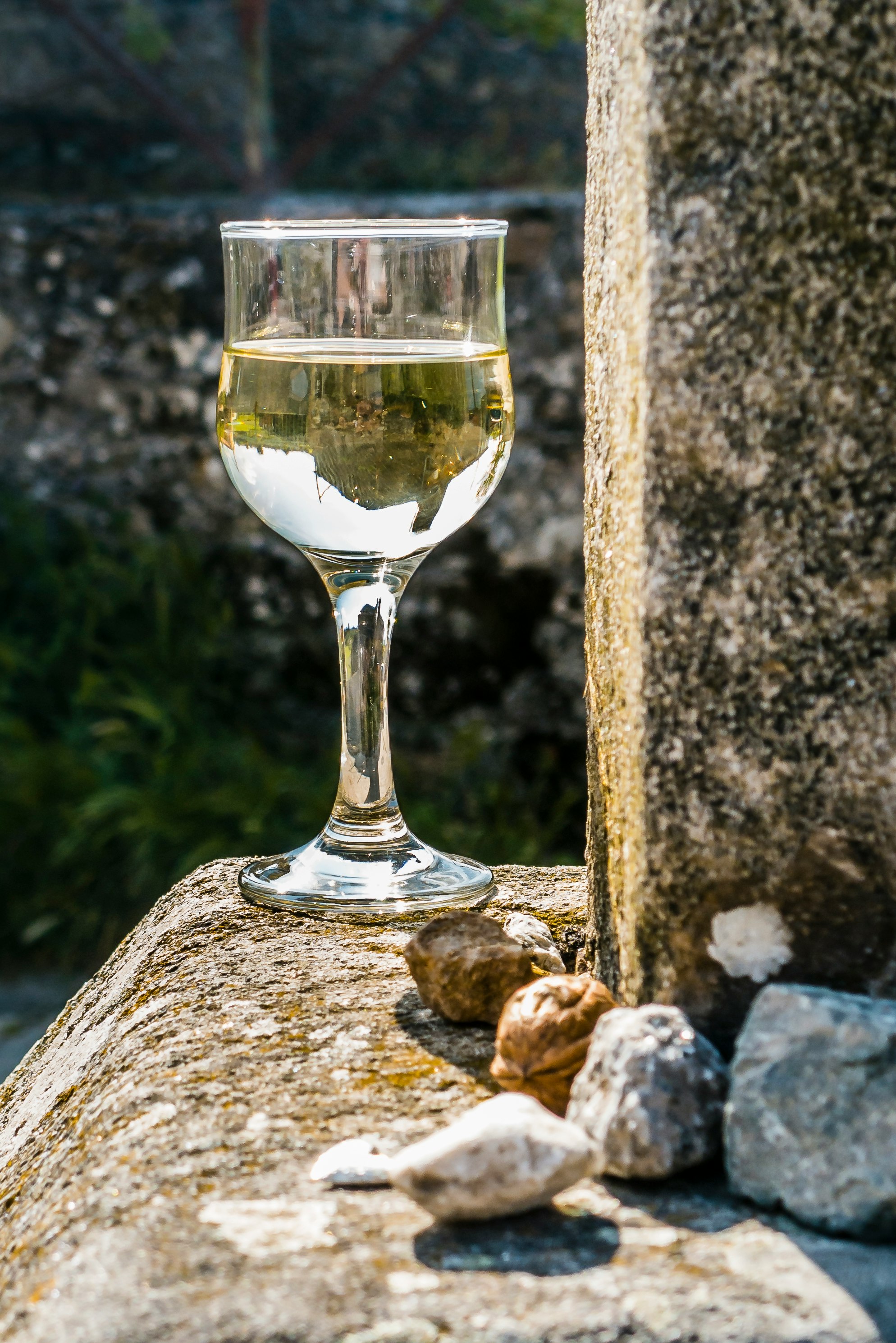 clear wine glass on brown rock