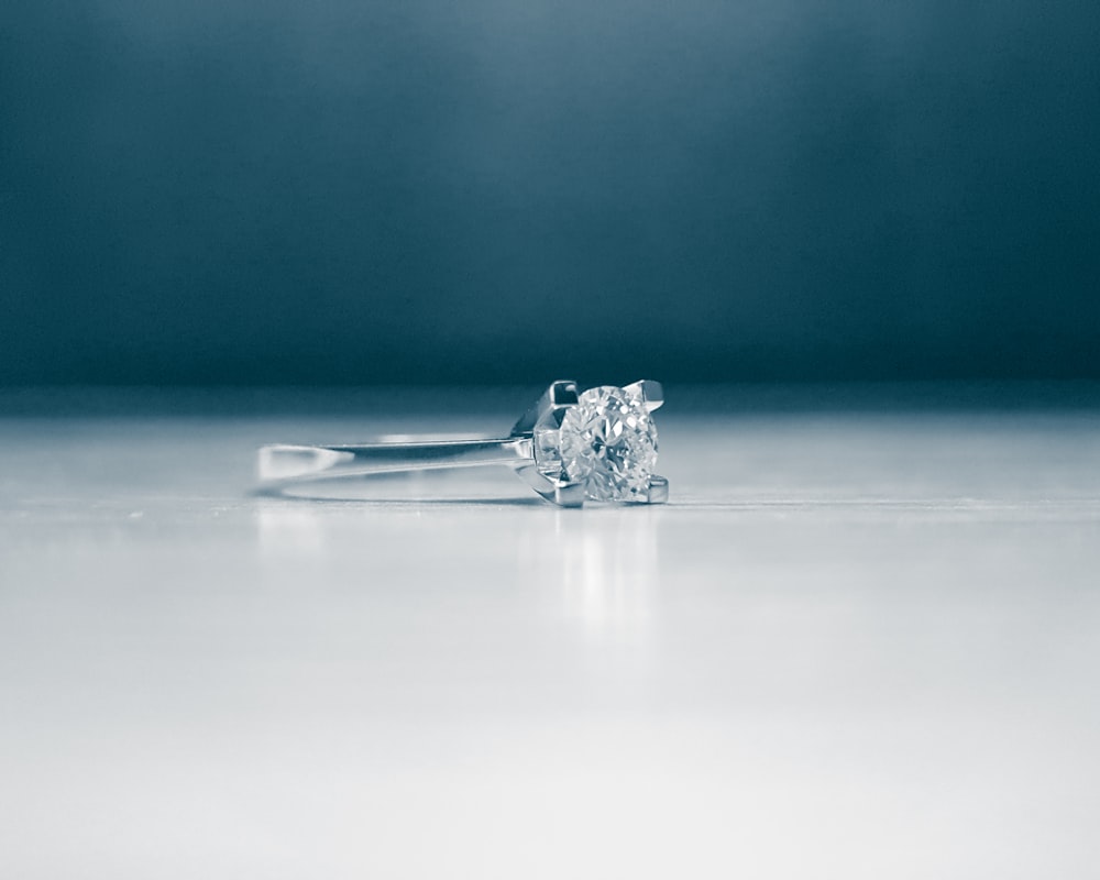 silver ring on white surface