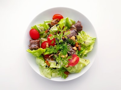 vegetable salad on white ceramic plate salad teams background