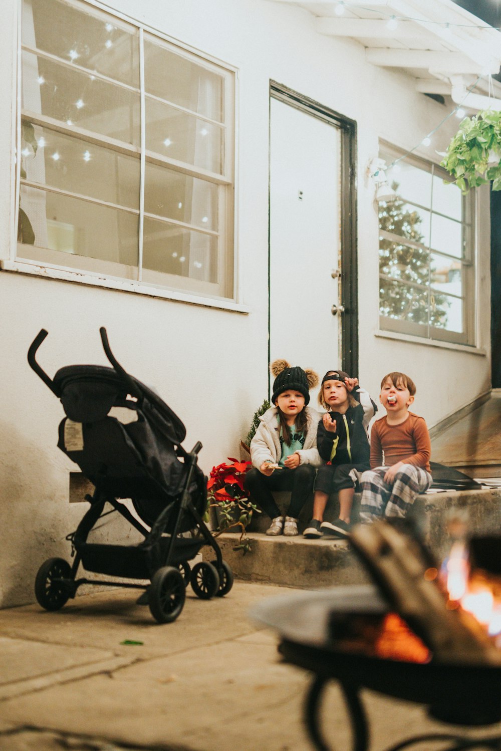 3 women and 2 men sitting on black stroller