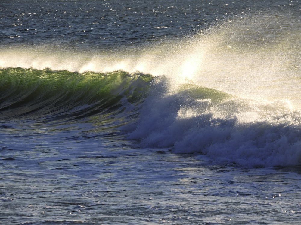 ocean waves crashing on shore during daytime