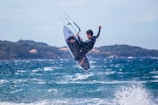 man in black wetsuit surfing on sea waves during daytime