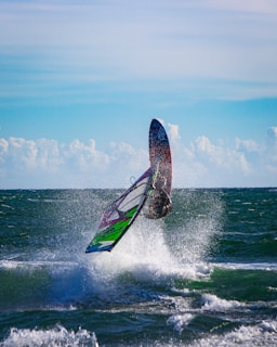 person surfing on sea waves during daytime