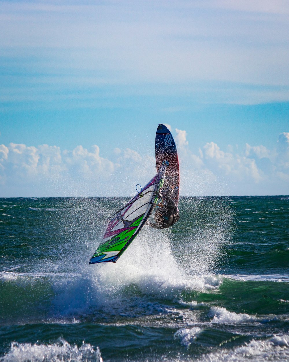 person surfing on sea waves during daytime