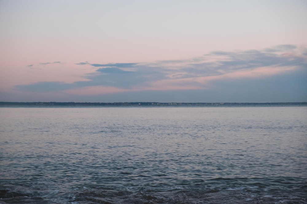 body of water under cloudy sky during daytime