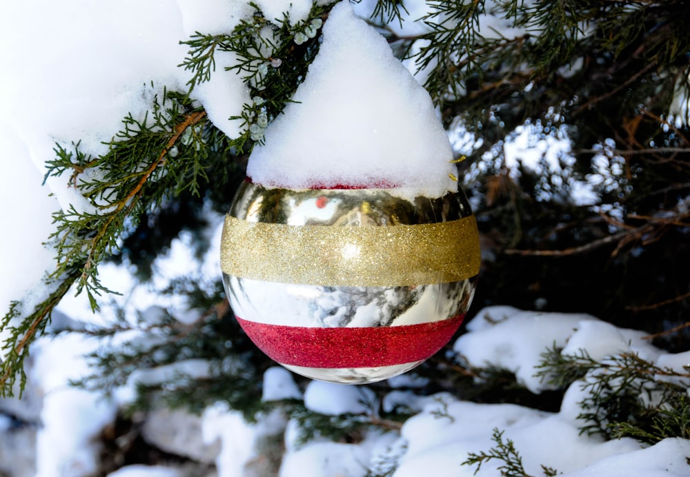 red and gold bauble on green christmas tree