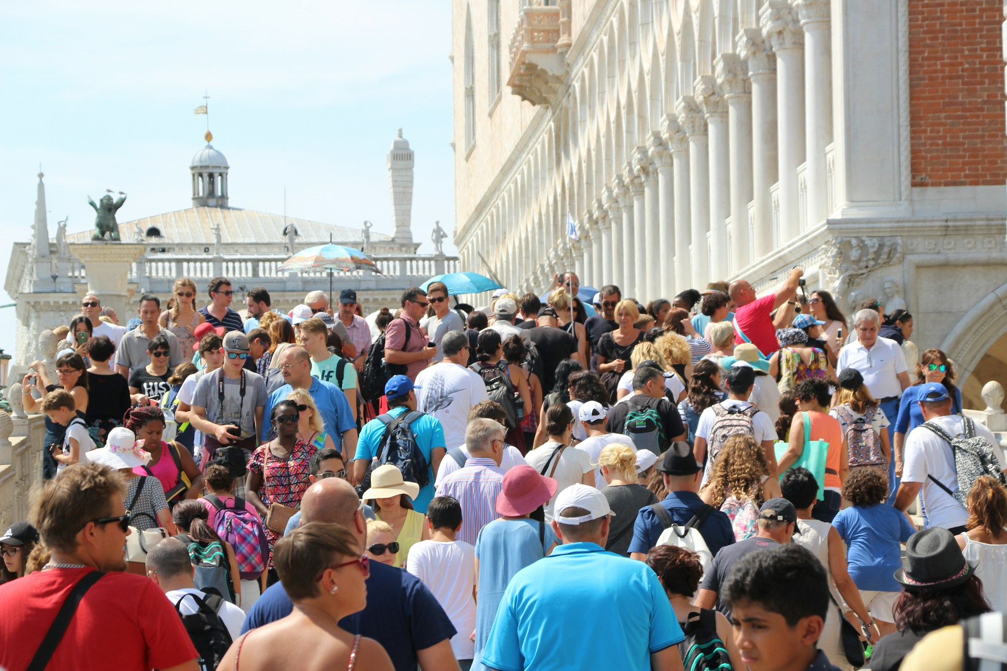 Crowds of tourists walking across a bridge in Venice