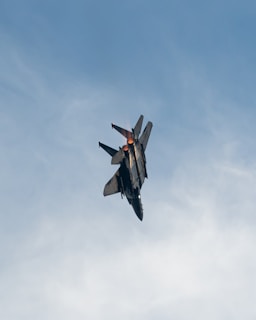 black and red jet plane in mid air